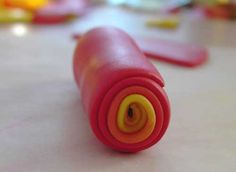 a close up view of a pink object with yellow tips on the top and bottom