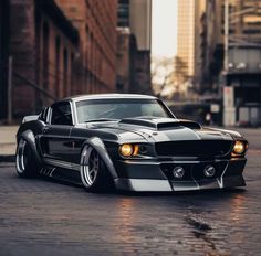 a black and white muscle car parked on the street