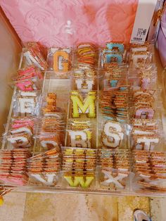 there are many cookies that spell out the word m and l on display in plastic containers