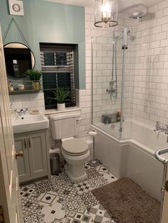 a bathroom with a toilet, sink and bathtub