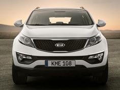 a man standing next to a white car with the words kme 108 on it