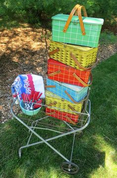 a stack of baskets sitting on top of a metal stand next to a green field