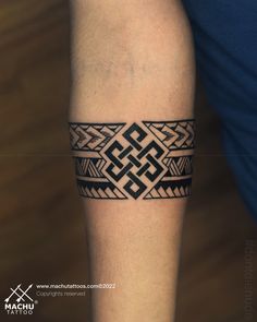 a man's arm with a tattoo on it and an intricate design in the middle