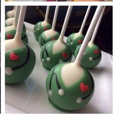 green cake pops with red hearts on them