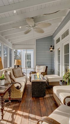 a living room filled with furniture on top of a hard wood flooring covered porch