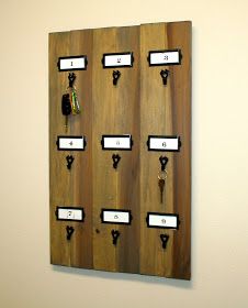 a wall mounted wooden board with keys and key hooks on it's sides,