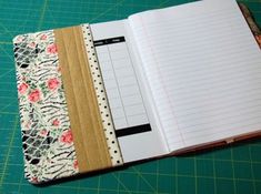 an open notebook sitting on top of a cutting board