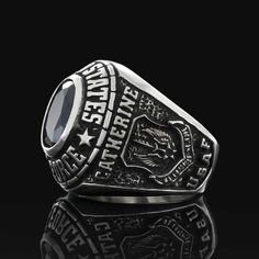 an image of a ring with the words and emblems on it, sitting on a black