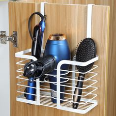 an organized cabinet with hairdryers and brushes