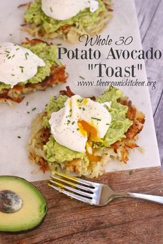 an avocado sandwich with eggs on top and some other toppings next to it