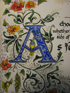 the letter a is decorated with flowers and leaves