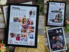 two framed pictures and some flowers on a wooden table with the calendar in front of them