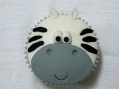 a cupcake shaped like a giraffe with eyes on it's head