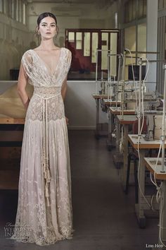 a woman is standing in an old factory