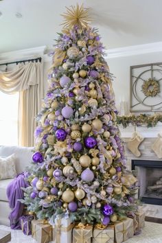 a decorated christmas tree with purple and gold ornaments