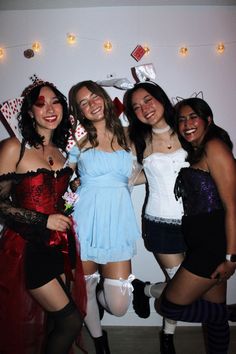 four women dressed up in costumes posing for the camera