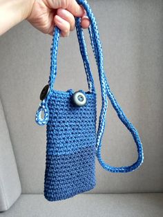 Cross Body phone bag, handmade crochet cotton bag in shades of blue, convenient smartphone bag, handmade gift for her, phone case holder Cross Body phone bag, handmade crochet cotton phone case in shades of blue, protective case for phone, for smartphone, phone cute handmade gift An elegant and unique protective case for a smartphone, glasses A unique and inimitable messenger bag for the phone or glasses, made of blue cotton string. Closed with a button with a loop, the strap is also adjustable with a button and a loop. A useful accessory for every woman not to hold the phone in her hand while walking. The perfect gift, a gift for any occasion, both for women and for men. Perfect for typical smartphones with maximum dimensions: 10.5 cm x 19.5 cm (4.15 inch x 7.70 inch). The belt has a tota Crochet Cotton Bag, Smartphone Bag, Phone Case Holder, Handmade Gifts For Her, Cotton String, Bag Handmade, Cotton Bag, Outfit Idea, Phone Bag