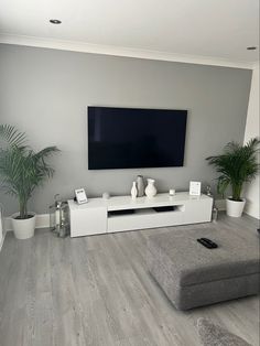 a large flat screen tv mounted to the side of a wall in a living room