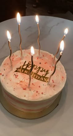 a birthday cake with candles that say happy birthday