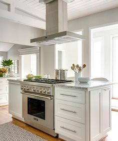 a kitchen with an oven, stove and counter top in it's center island