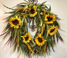 a wreath with sunflowers is hanging on the wall