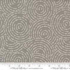 a gray and white fabric with small circles on the side, as well as a ruler