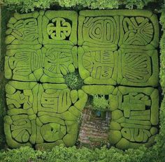 an aerial view of a maze in the grass