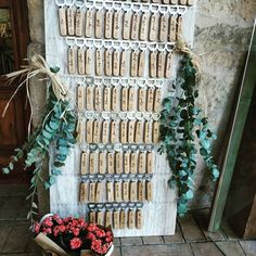 there is a wall display made out of wine corks with flowers on the bottom