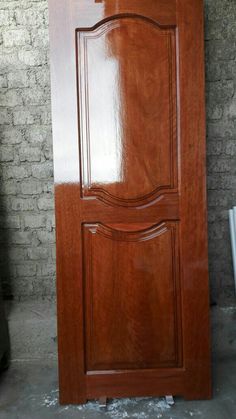 a wooden door is shown in front of a brick wall