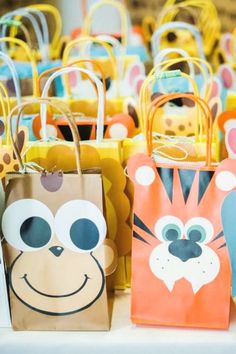 small bags with animal faces on them sitting on a table