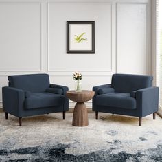 a living room with two chairs and a table in front of the wall, along with a rug on the floor