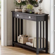 a black console table with flowers on top