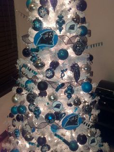 a white christmas tree with blue and silver ornaments