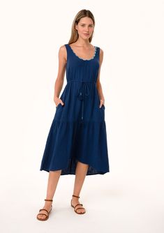 [Color: Navy] A front facing image of a blonde model wearing a navy blue cotton sleeveless mid length dress. With a scooped neckline Summer Beach Midi Dress With Drawstring, Summer Midi-length Dress With Drawstring, Summer Midi Length Dress With Drawstring, Navy Cotton Midi Dress, Summer Knee-length Midi Dress With Drawstring, Summer Midi Dress With Drawstring, Casual Sleeveless Midi Dress With Tie Waist, Sundress With Drawstring In Maxi Length, Daywear Midi Dress With Drawstring