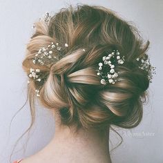 the back of a woman's head with flowers in her hair