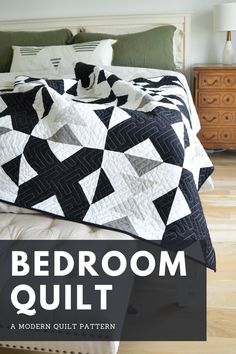 a bed with a black and white quilt on it, the text reads bedroom quilt a modern quilt pattern