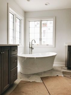 a bath tub sitting in the middle of a bathroom