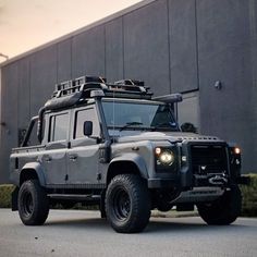 an suv parked in front of a building with lights on it's roof rack