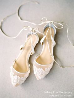 a pair of white shoes tied to a string