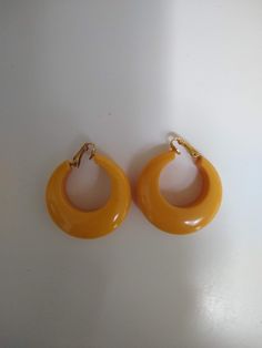 "Vintage Butterscotch / Creamed Corn Yellow Bakelite Clip-On Hoop Earrings, Retro Chunky Hoop Earrings, Mod Clip-Ons.  Likely from the 40's.  Well made - Clips are inserted into a drill hole in the plastic, not just glued on.  Very good condition. About 1 1/2\" diameter x 1/2\" thick." 60s Earrings, Future Album, 60s Jewelry, 60s Look, Creamed Corn, Chunky Hoop Earrings, Chunky Earrings, Vintage Earrings, Clip On Earrings