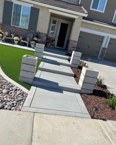 a house with landscaping in front of it and grass on the ground next to it