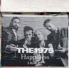 a large poster on the side of a building that says he07 happiness 3 august