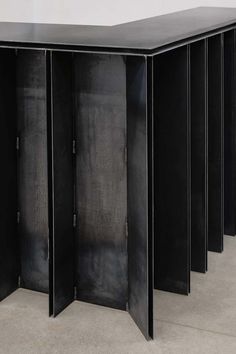 four black metal lockers sitting side by side