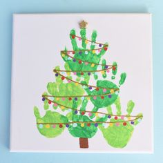 a handprint christmas tree on a white canvas