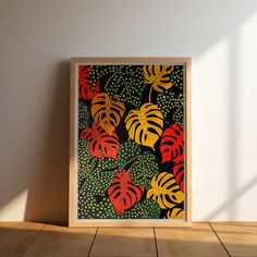 a painting on the wall next to a tile floor with a plant pattern in red, yellow and green