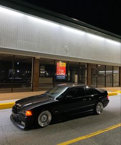 a black car parked in front of a building