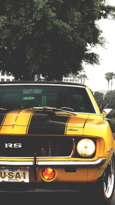 a yellow and black car is parked on the street