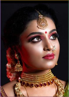 a woman with makeup and jewelry on her face