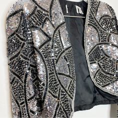 Vintage Silk Beaded Jacket Ornate Heavy Silver Metallic Bolero Loehmann's Black And Silver Sequin And Beading In Art Deco Design Has Had Designer Label Removed As Shown In Photo - But Still Has Vintage Loehmann's Tag Attached Size Small One Shoulder Has Slight Flaw In Sequins As Shown In Final Photo - Otherwise Stunning, No Other Flaws I Can Find This Is A Heavy, Gorgeous, Rare, Vintage Jacket. Perfect For Holidays, Weddings Elegant Silver Sequined Outerwear, Fitted Silver Sequined Outerwear, Silver Sequined Outerwear For Evening, Silver Sequined Evening Outerwear, Silver Glamorous Formal Outerwear, Glamorous Silver Formal Outerwear, Glamorous Fitted Silver Outerwear, Silver Fitted Outerwear For Evening, Silver Long Sleeve Outerwear For Evening