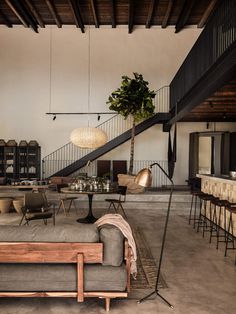 a living room filled with furniture next to a staircase